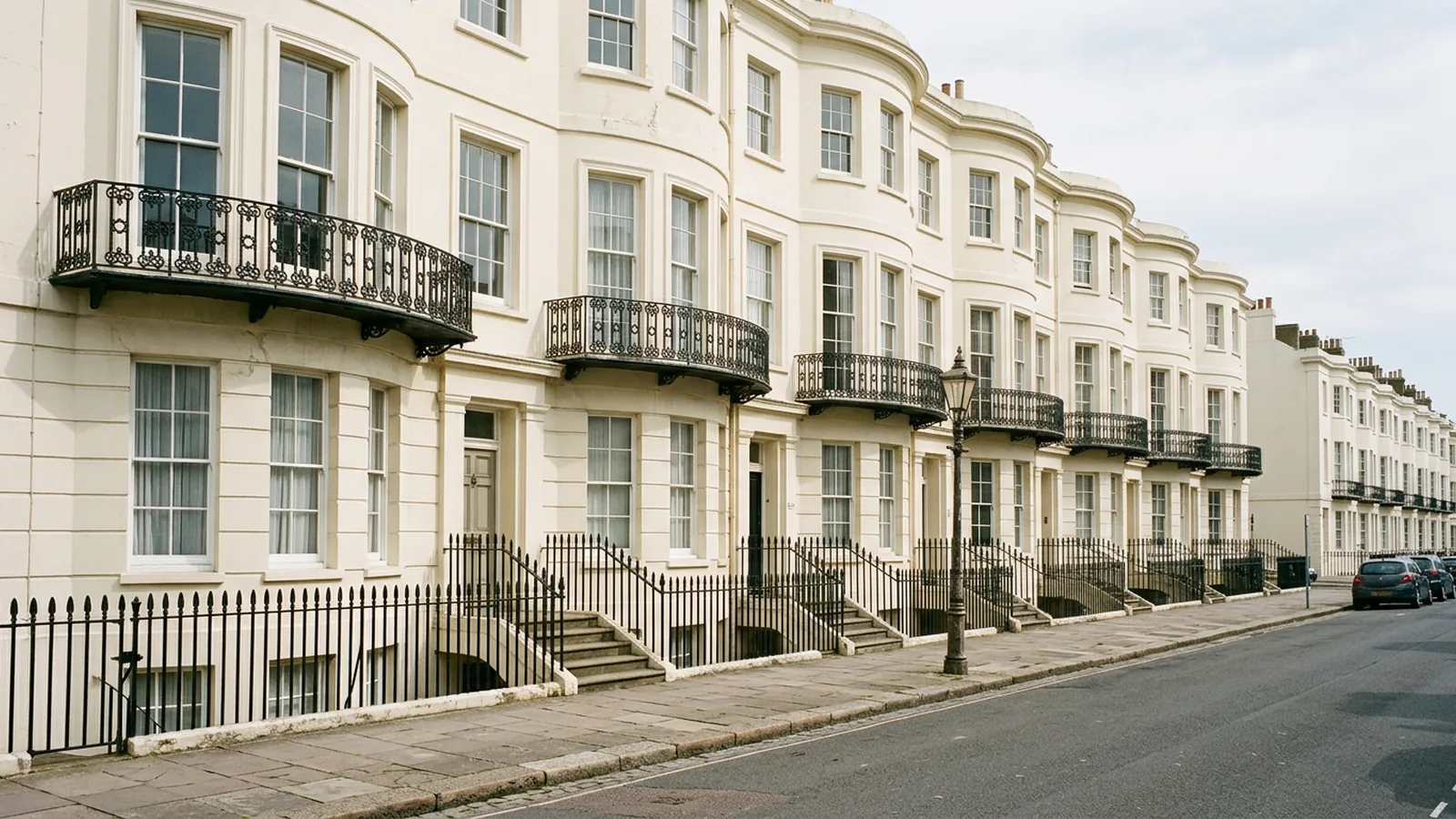 Regency crescent with iron balconies and rows of white sash windows